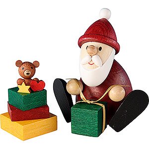 Kleine Figuren & Miniaturen Weihnachtsmann Weihnachtsmann mit Geschenk und Geschenkestapel - 8,3 cm